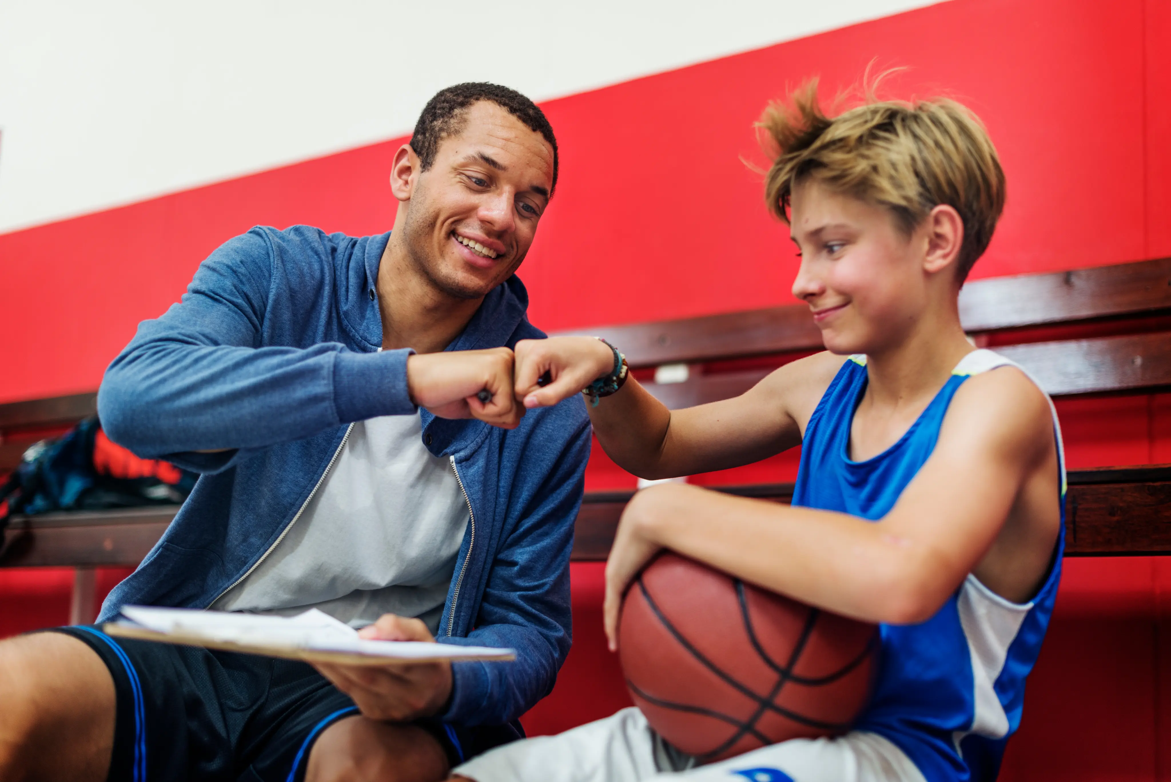 Coach and student fist bumping